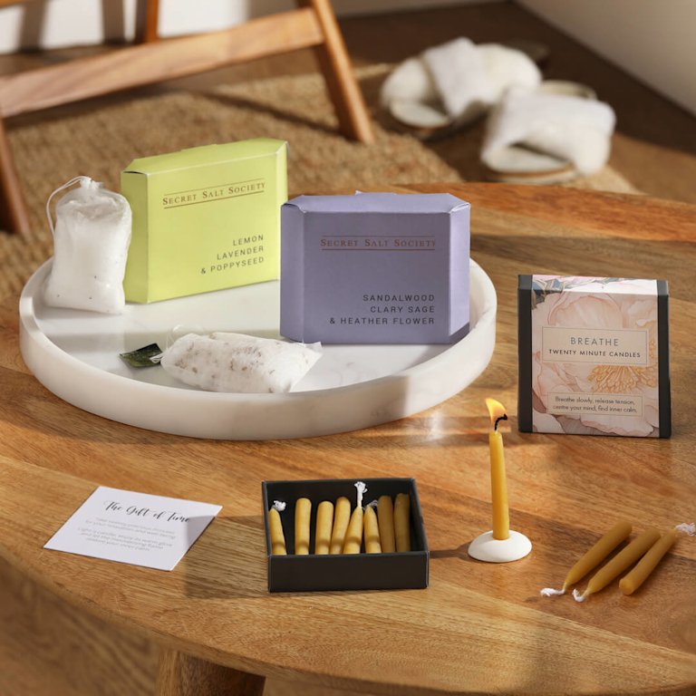 Bloom & Wild 'The Letterbox Minful Moment' gift, consisting of mini 10 minute candles and relaxing bath salts in cotton pouches, displayed on a ceramic tray.