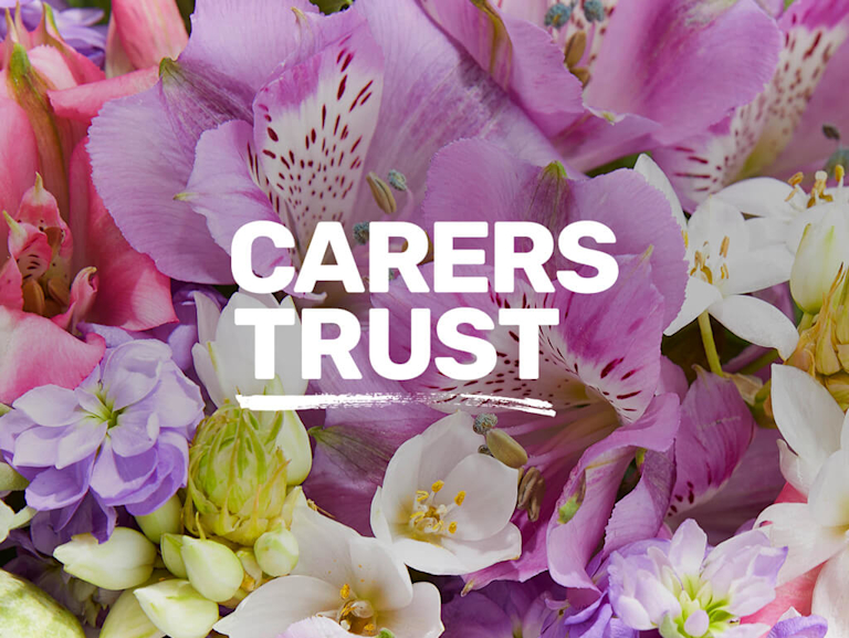 Carers Trust's logo appears in front of a floral background.