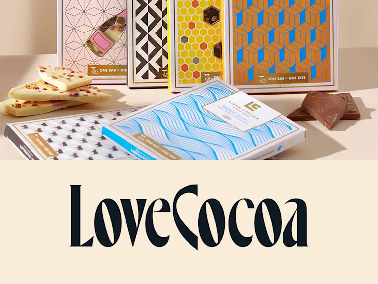 Six bars of chocolate wrapped in eye-catching, artistic designs, next to the Love Cocoa logo