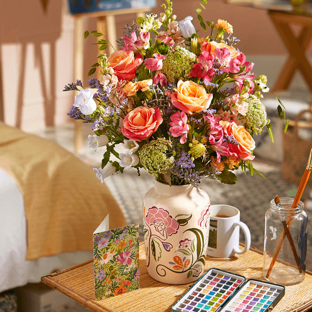Bloom & Wild 'Helen' bouquet in a vase upon a side table