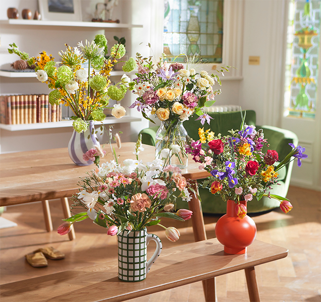 Pink bouquet of Bloom and Wild flowers in a dark blue vase
