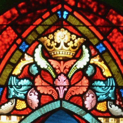 close up of colorful stained glass window showing a crown