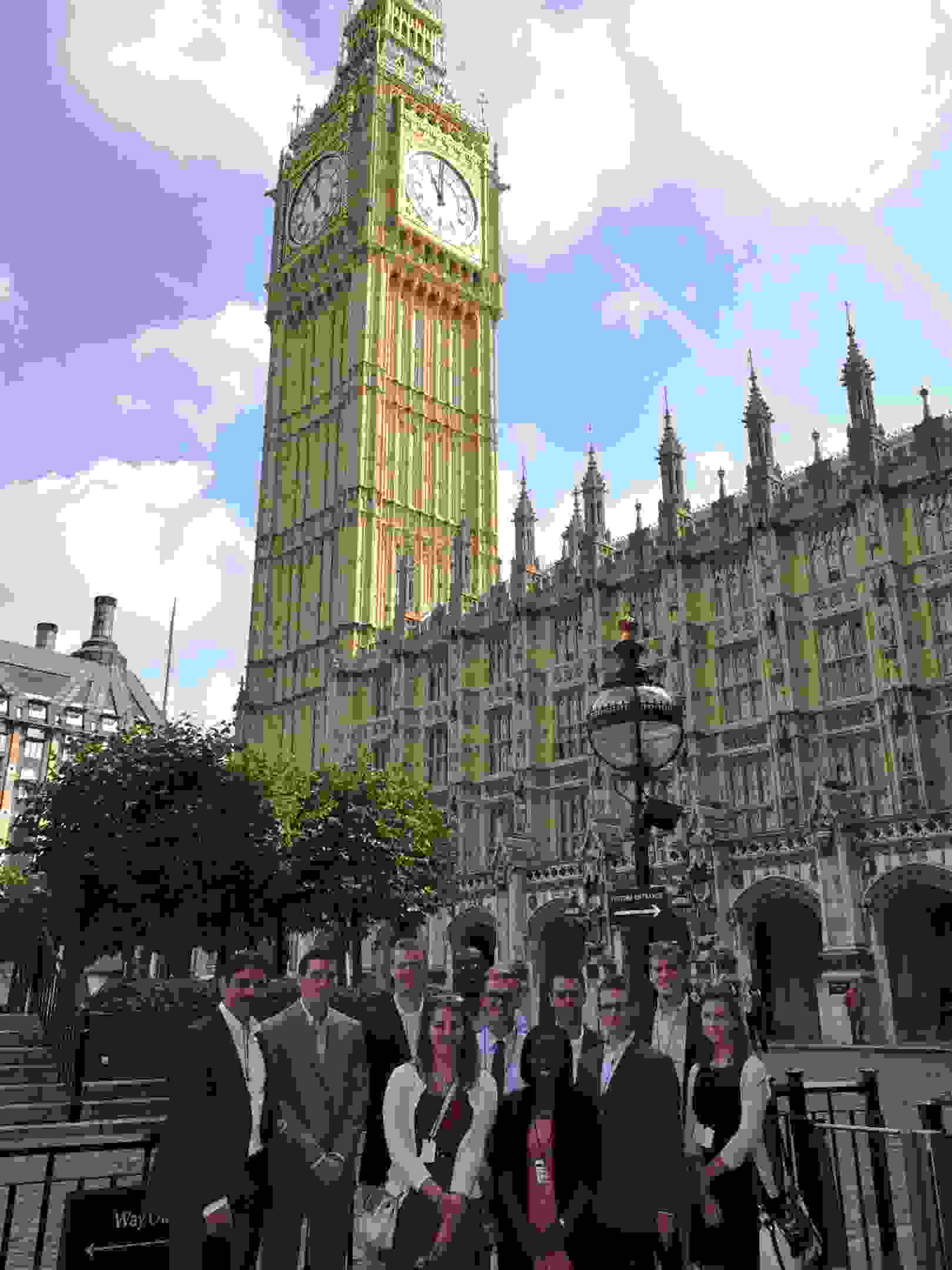 Photo of Hansard Society Scholars in the courtyard to the Palace of Westminster, standing in front of Big Ben, UK Houses of Parliament