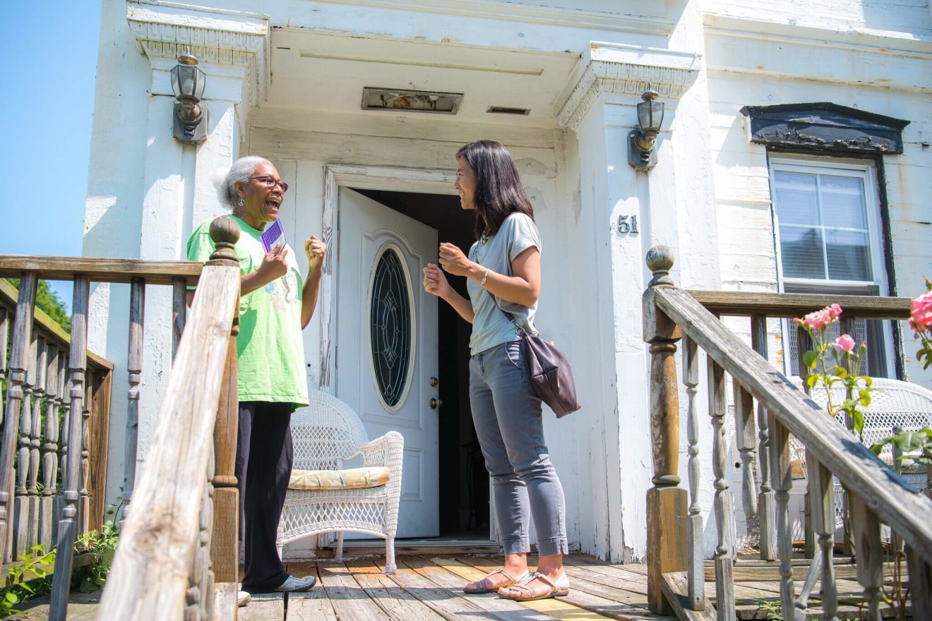 Michelle Wu speaks to a Boston constituent while canvassing across the city.