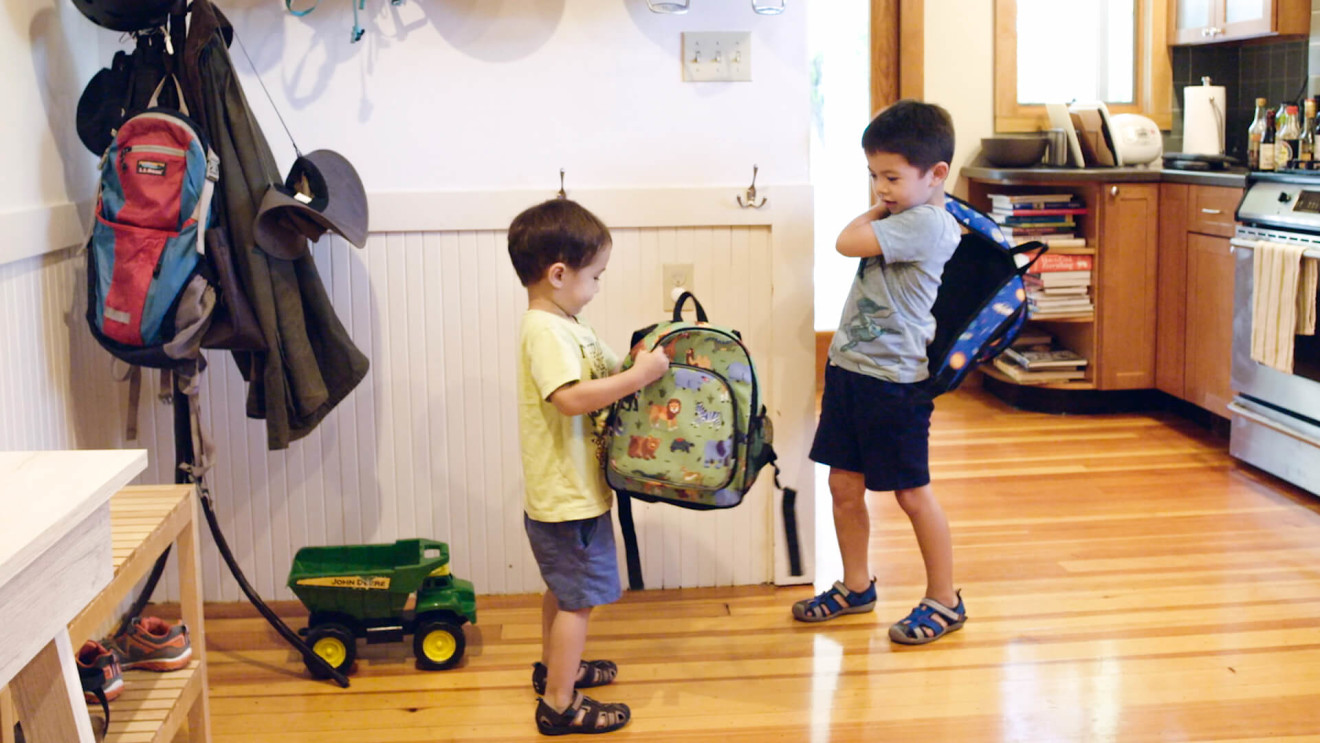 Michelle Wu's sons put on their backpacks for school.