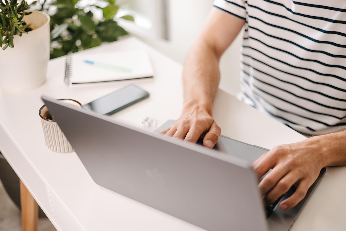 A person typing on their laptop.
