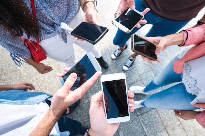 friends in a circle holding phones