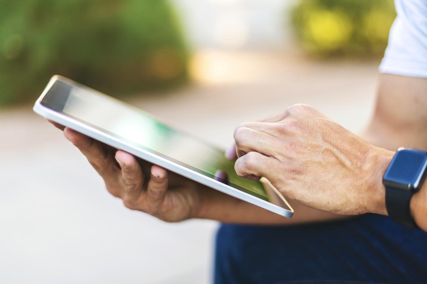 A person using their tablet.