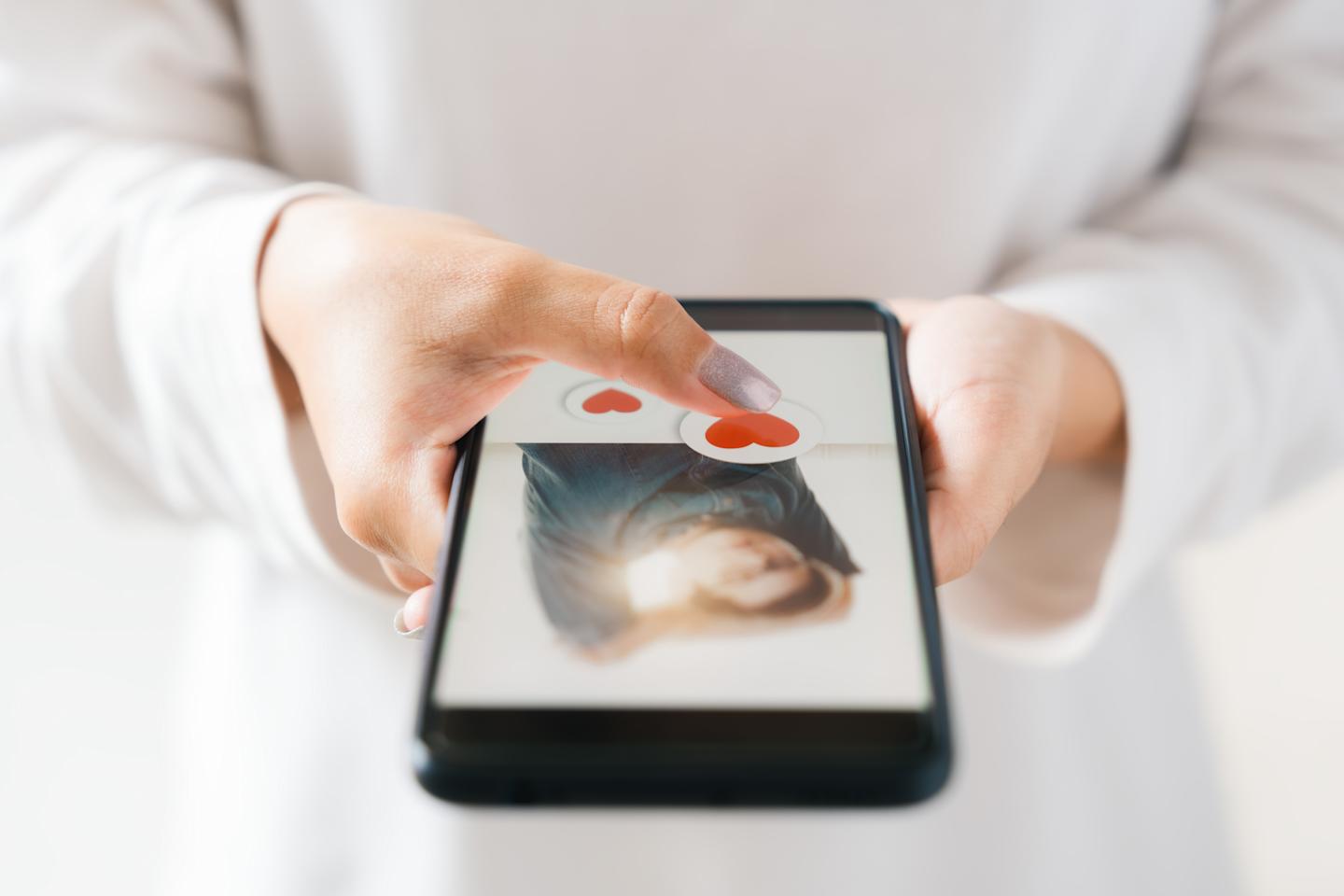 A person using an online dating app on their smartphone.
