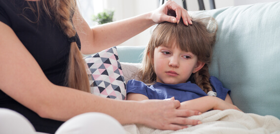 Mother attending to her sick child