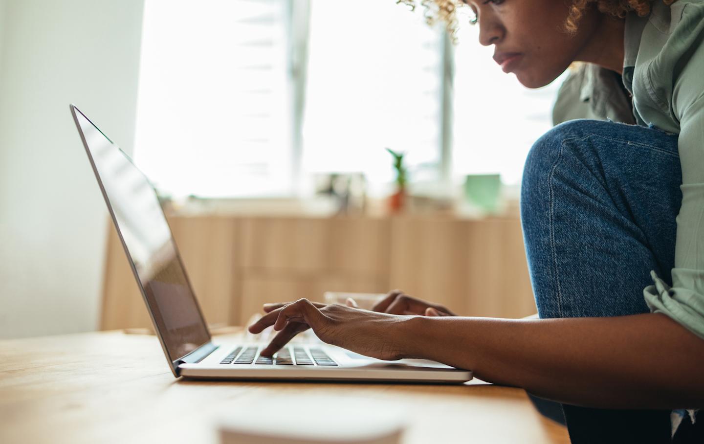 A person typing on their laptop.
