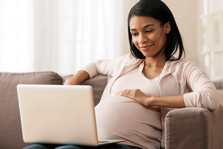 Pregnant woman using laptop
