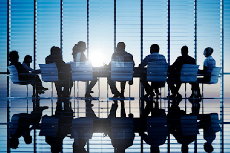 Image of law makers gathered around conference table in board room