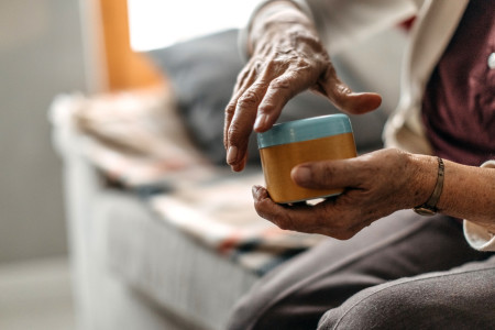 older woman opening jar