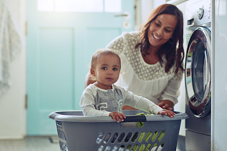 Mother and toddler doing laundry