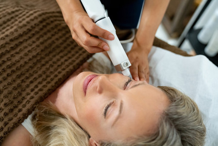 Dermatologist using laser treatment on a patient with Rosacea