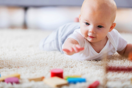 baby crawling on a rug
