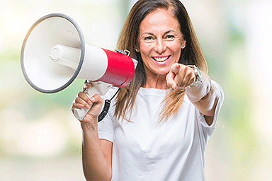 Middle age woman holding a megaphone with finger pointing to you
