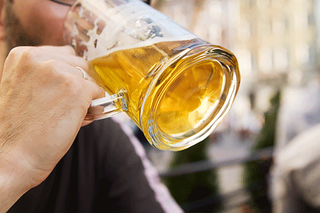Man drinking beer from a beer mug