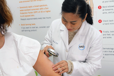 Dermatologist performing a free skin cancer screening