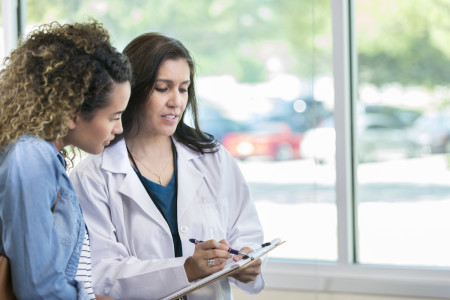 Dermatologist talking with patient