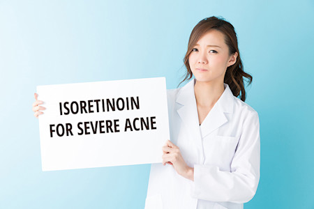 Doctor showing sign with isoretinoin fir severe acne