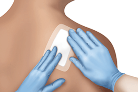 Dermatologist applies bandage after skin biopsy