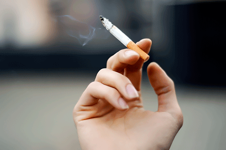 Close up of a cigarette in a person's hand