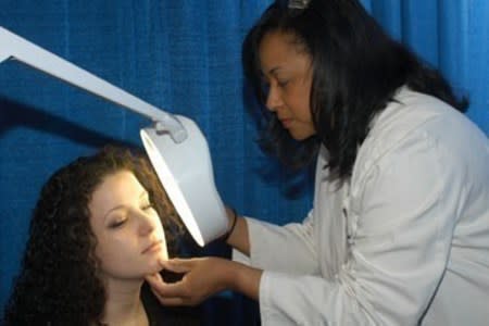 Dermatologist perfoming skin exam