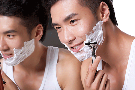 Man smiling while shaving