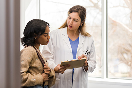 Woman receiving supplement recommendations by her doctor