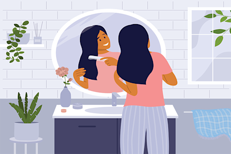 girl brushing hair in mirror