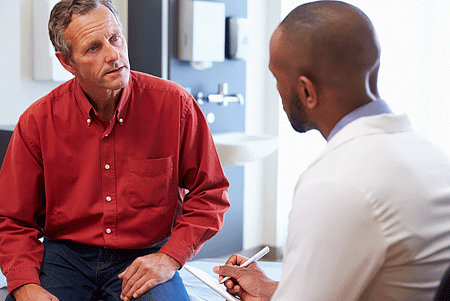 Male patient meeting with male dermatologist for medical treatment