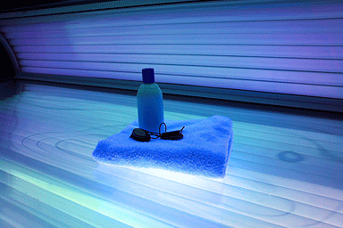 Indoor tanning bed with towel and protective eye goggles