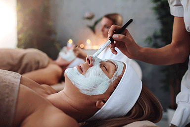 Woman enjoying a facial beauty treatment in a spa center