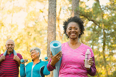 Senior group of men and women exercising outdoors.
