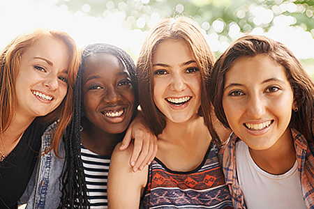 A close-up cropped image of four young teenage girls