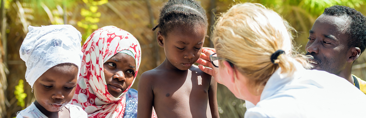 A dermatologist examining a young patient