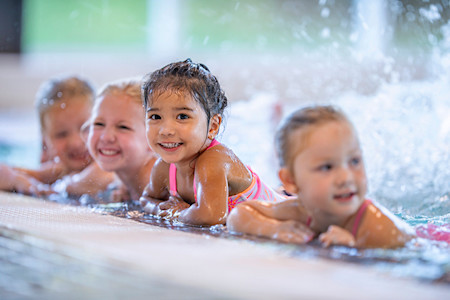 Kids in swimming pool splashing