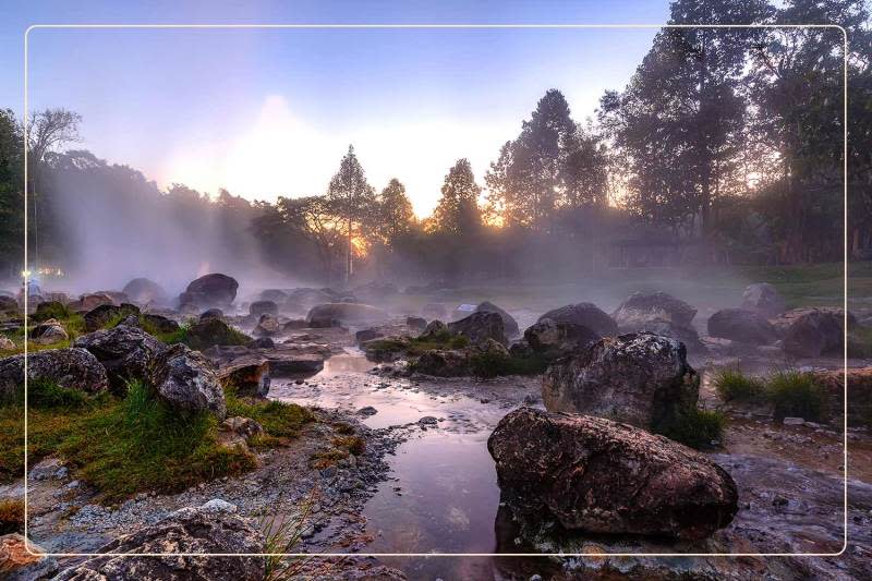 mist rises off a rock formation at Hot Springs National Park, a dog-friendly national park where one can go hiking with dogs