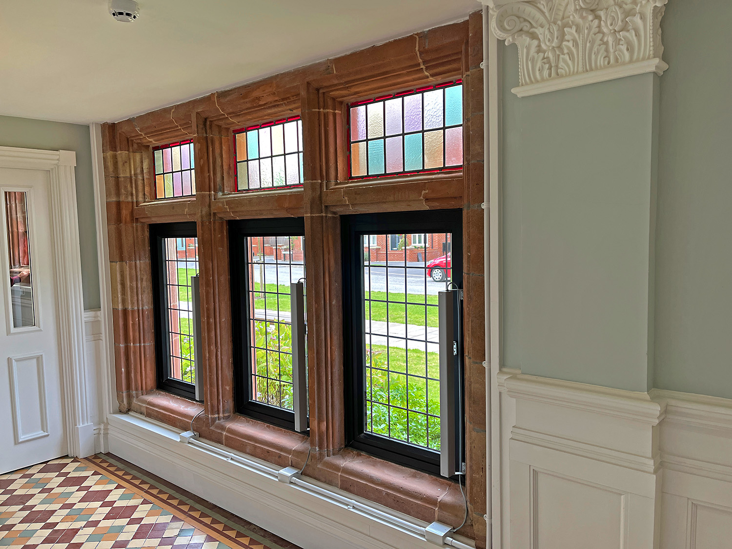 Decorative columns and leaded glass windows were updated and preserved.