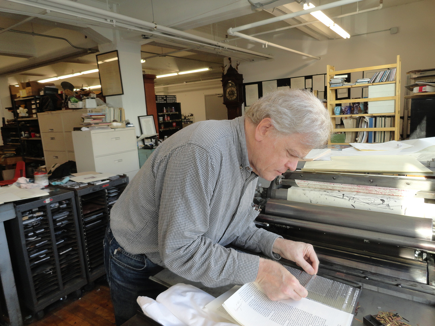 Bruce Kennett inserting a Linotype slug on press