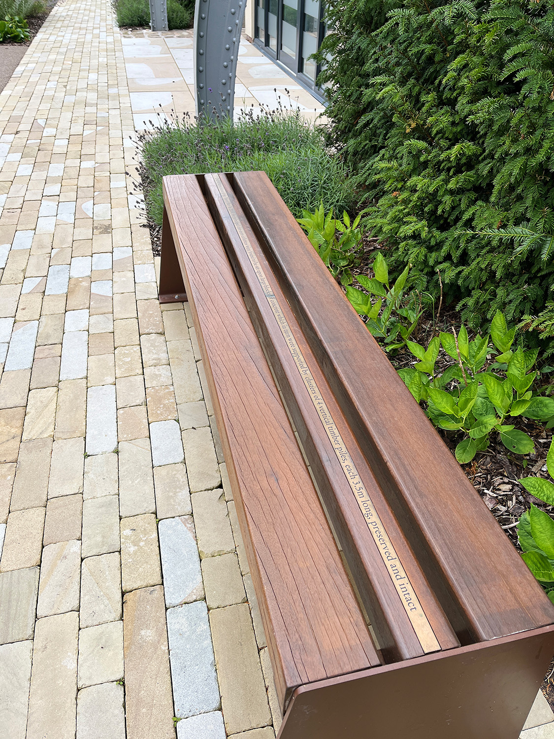 Exterior benches have information about the company and typefaces integrated into their design.