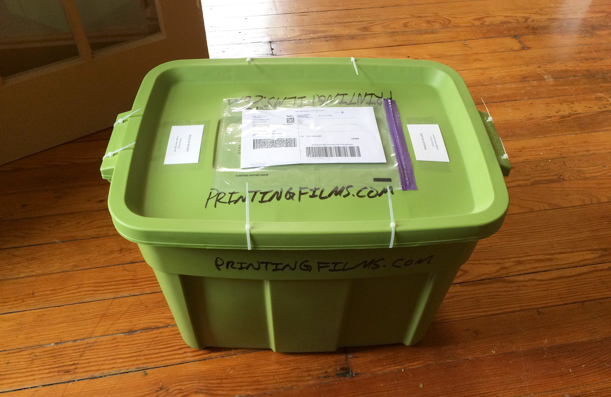 How do you ship off a dozen films to be digitized and make sure they survive FedEx? Buy a rubber container and use zip-ties: that’s how.