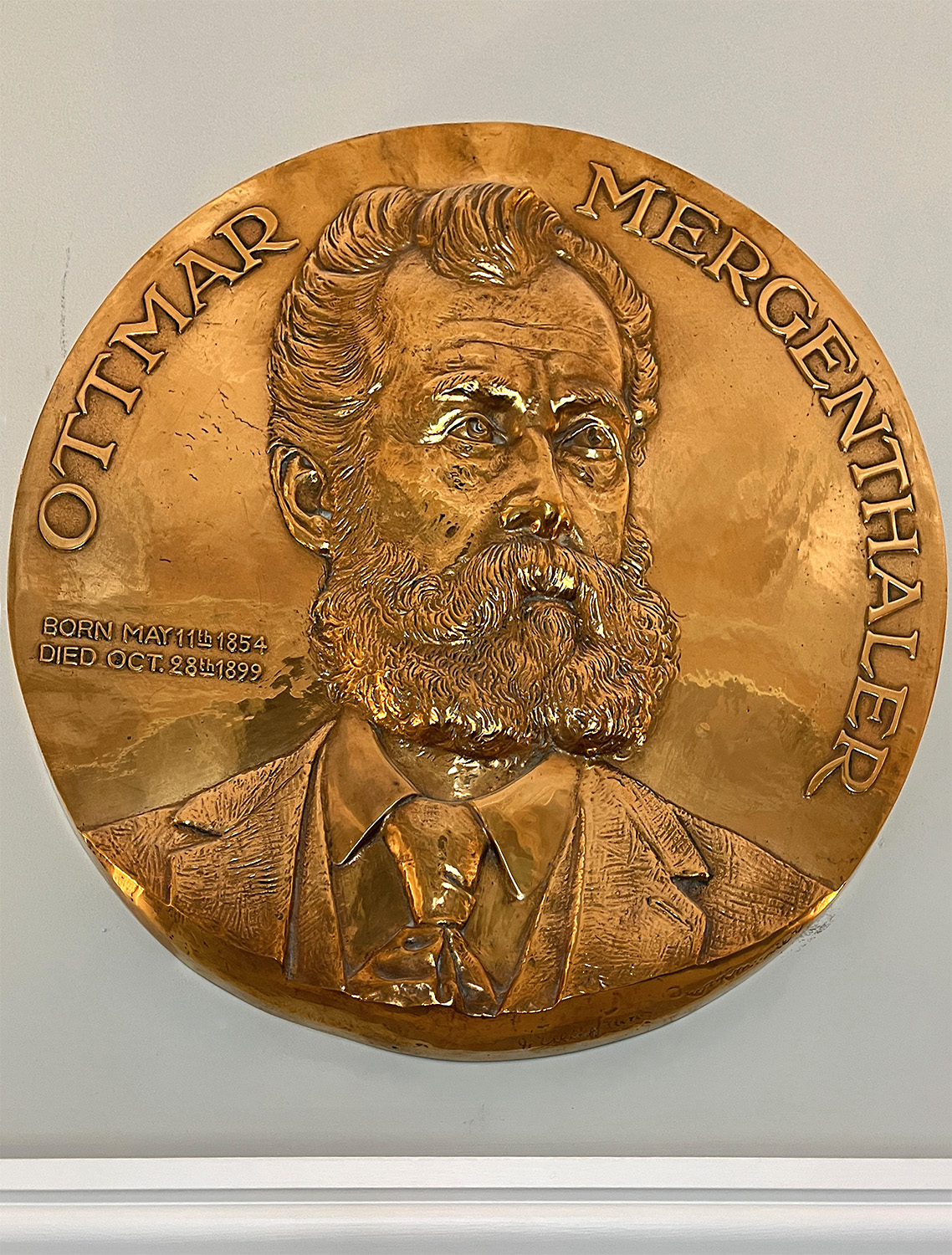 A gold plaque above a door in the upper hallway honors Ottmar Mergenthaler.