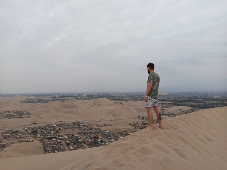 Sandboarding dunes in Huacachino close to Ica, Peru