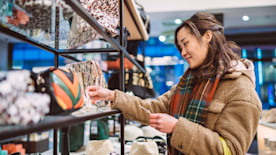 Young woman shopping for accessories in boutique