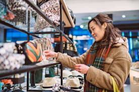 Young woman shopping for accessories in boutique