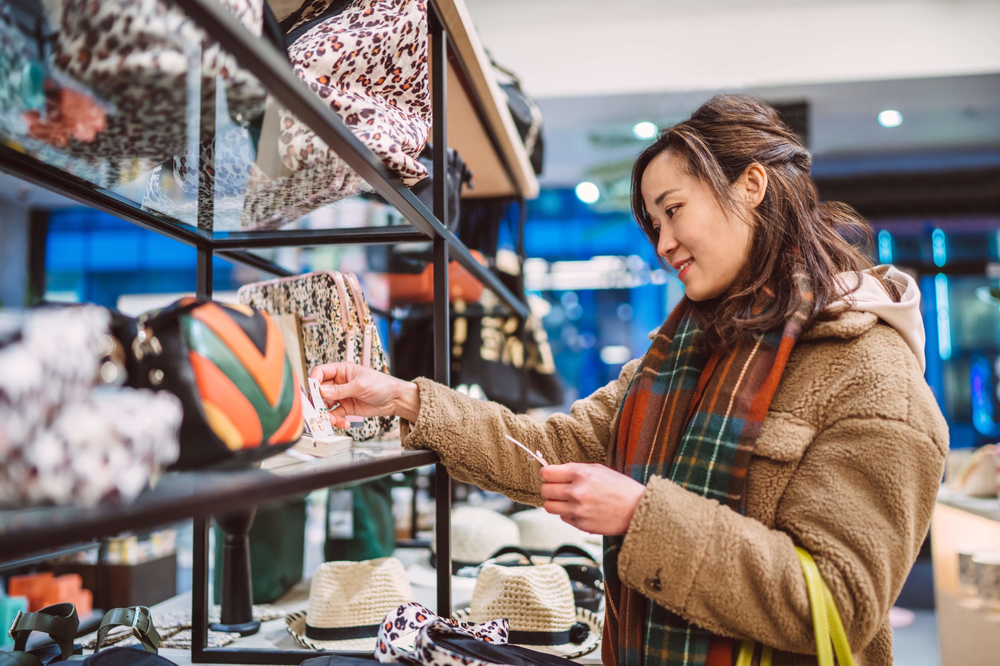 Young woman shopping for accessories in boutique