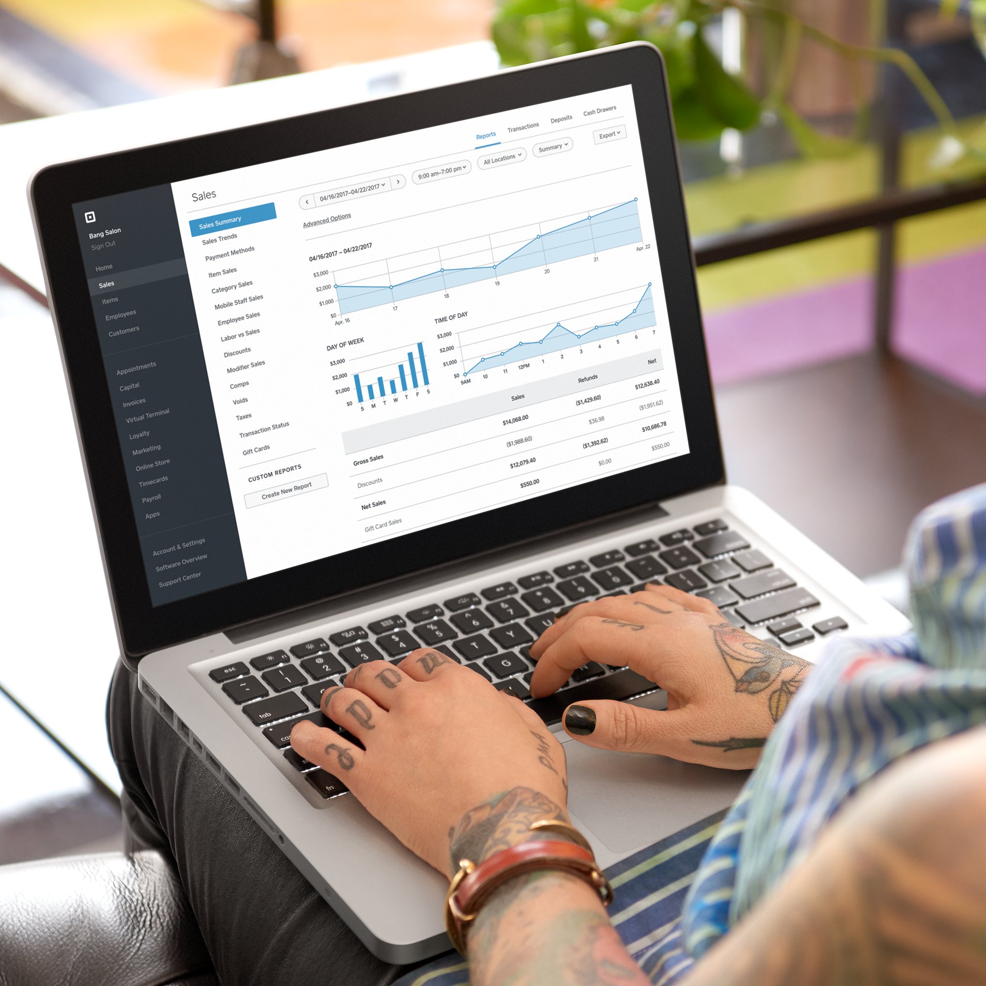 Photo of a woman using Square Analytics on a laptop